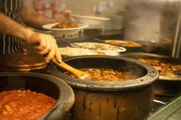 Photo midsection of person preparing food in kitchen