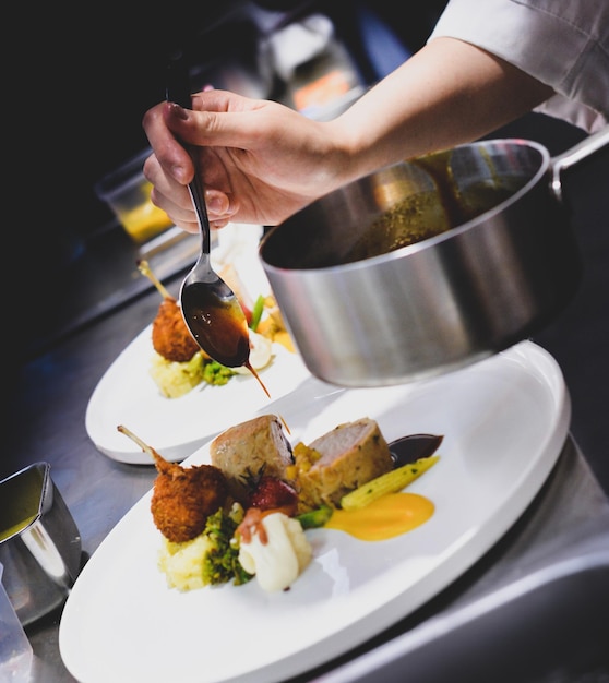 Midsection of person preparing food in plate