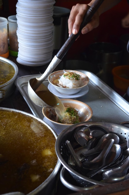 Midsection of person preparing food in restaurant