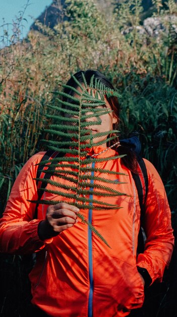 Photo midsection of person standing against plants