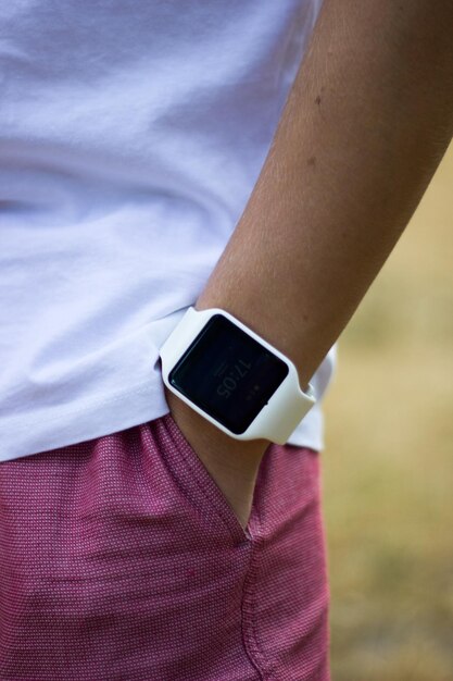 Photo midsection of person wearing smartwatch