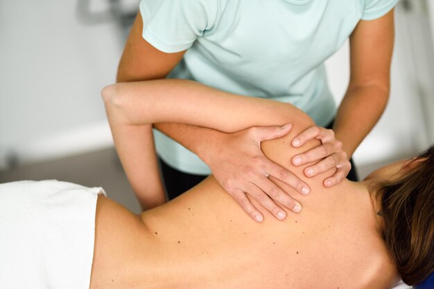 Photo midsection of physical therapist massaging client