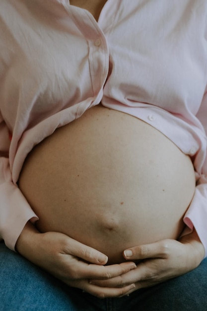 Midsection of pregnant woman holding hands