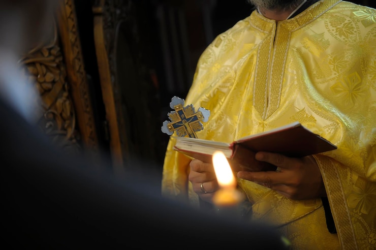 Photo midsection of priest holding bible while standing in church