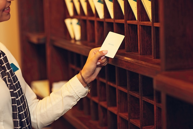 Midsection of receptionist with key cards