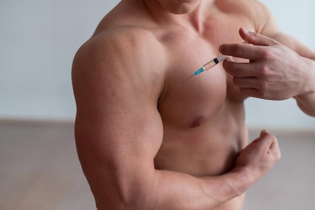 Photo midsection of shirtless man holding tape measure