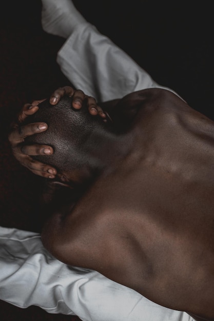 Photo midsection of shirtless man lying on bed