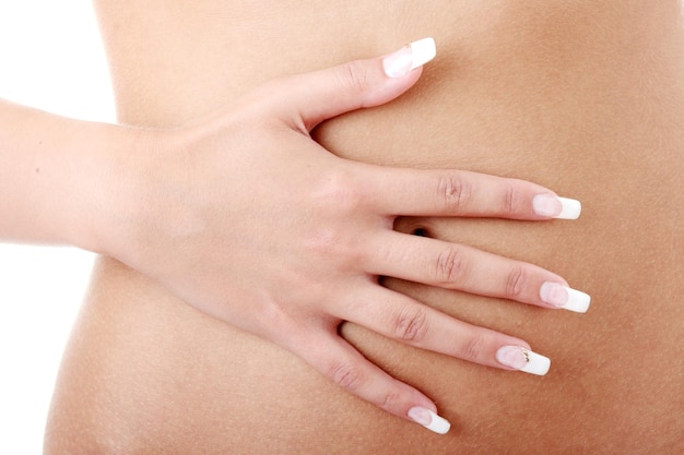 Midsection of shirtless woman against white background