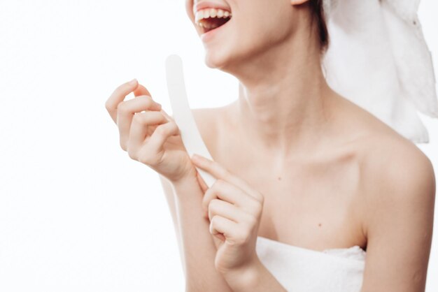 Midsection of shirtless woman holding hands against white background