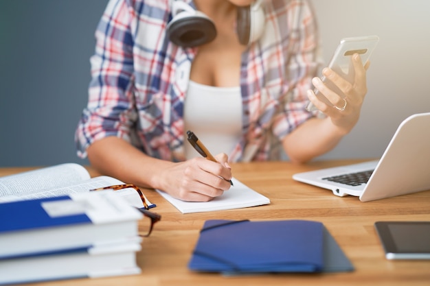 Photo midsection showing female student learning at home