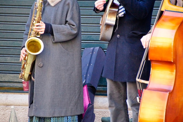 Photo midsection of street musicians playing music in city