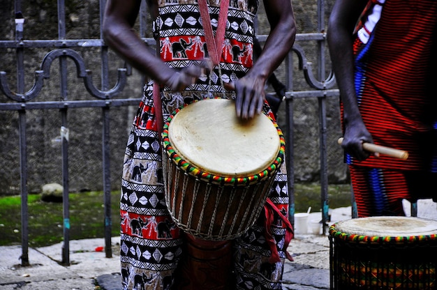 midsection of street performers playing bongo
