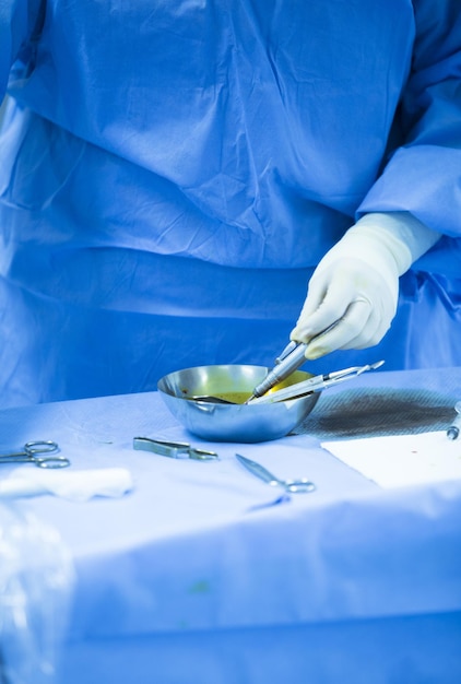 Midsection of surgeon holding medical equipment at hospital