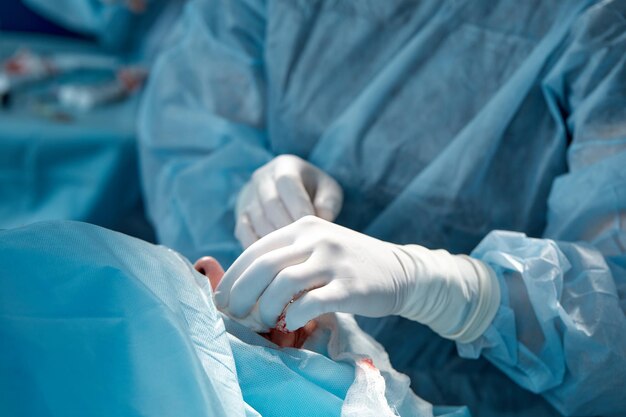 Midsection of surgeon operating in hospital