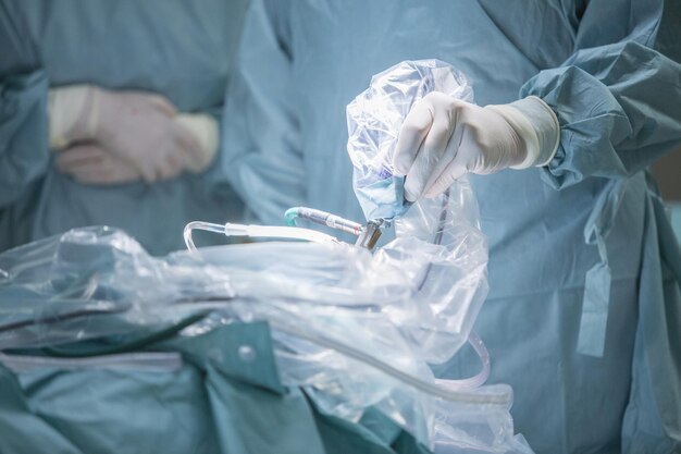 Photo midsection of surgeon operating patient at hospital