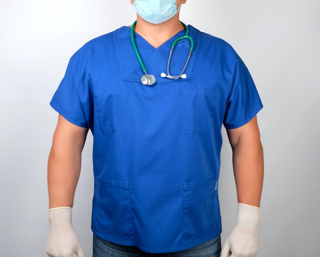 midsection of surgeon standing against white background