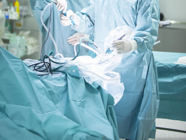 Midsection of surgeons working in operating room