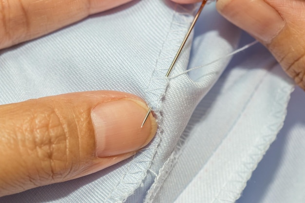 Photo midsection of tailor sewing textile