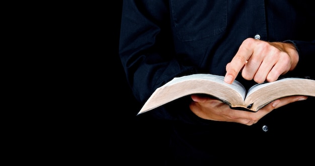 Midsection view of man holding holy bible