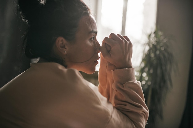 Midsection of woman drinking glass window