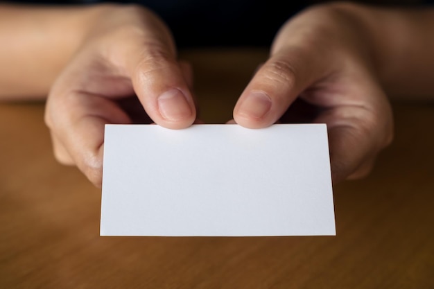 Midsection of woman giving placard while sitting at restaurant