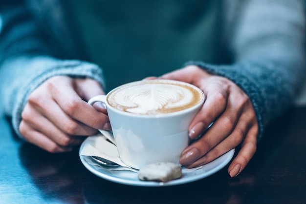 Midsection of woman having drink