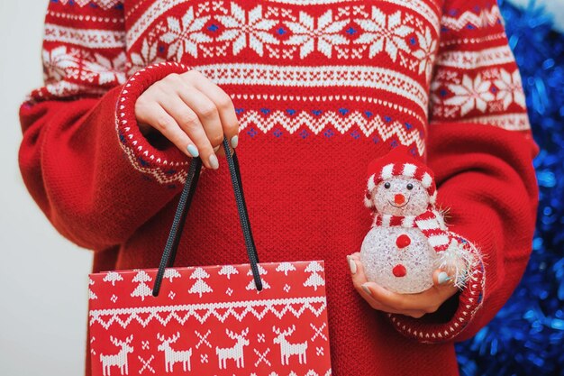 Midsection of woman holding bag during christmas