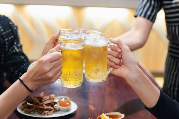 Midsection of woman holding beer glass