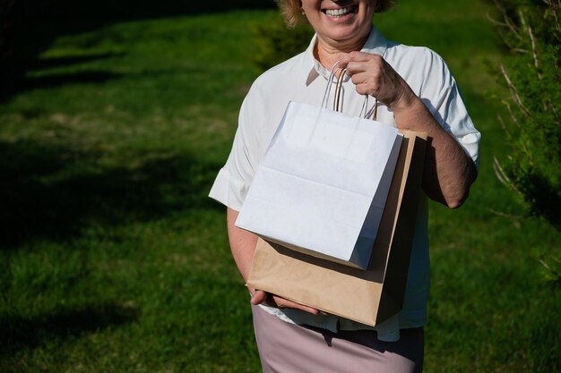 Midsection of woman holding book while standing on field