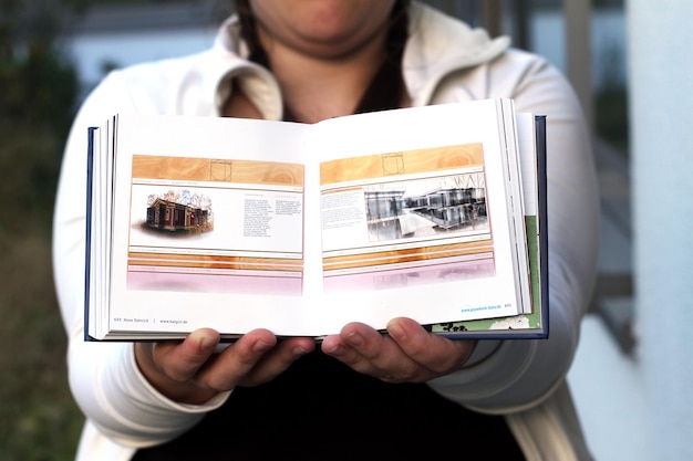 Photo midsection of woman holding books for sale