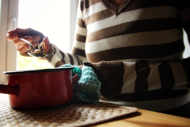 Midsection of woman holding bowl