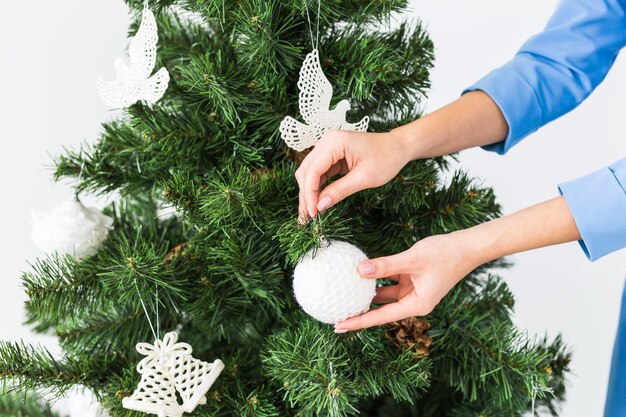 Foto sezione centrale di una donna che tiene l'albero di natale