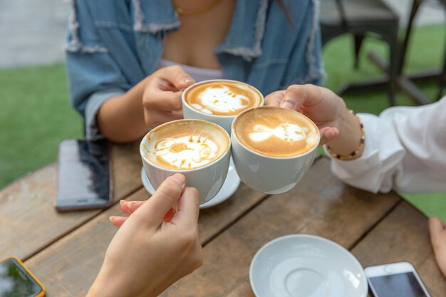 Midsection of woman holding coffee cup on table