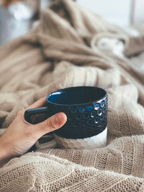 Midsection of woman holding coffee cup