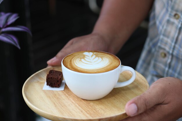 コーヒーカップを握っている女性の中央部分