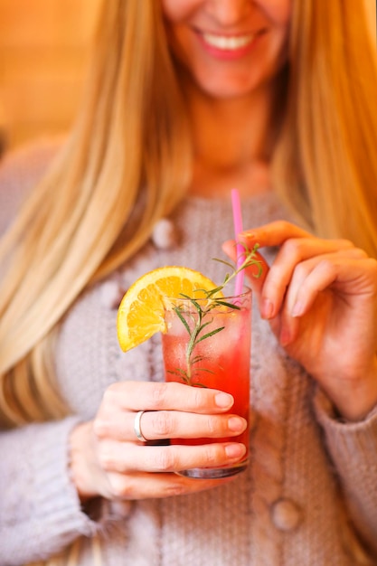 Midsection of woman holding drink