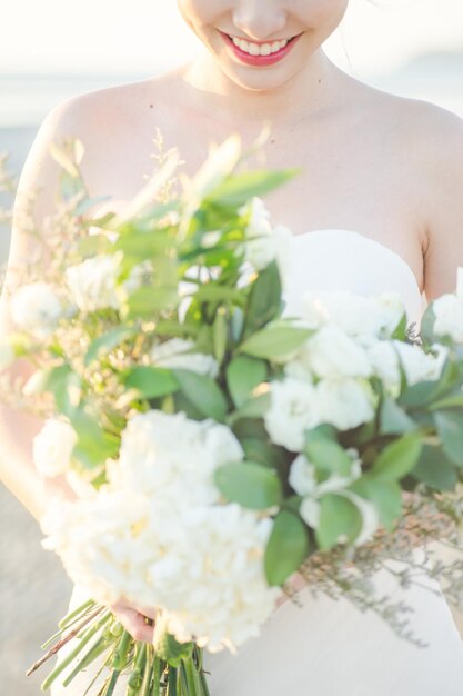 Midsection of woman holding flower bouquet