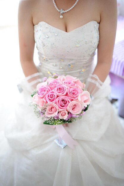 Midsection of woman holding flower bouquet