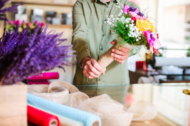 Midsection of woman holding flower bouquet