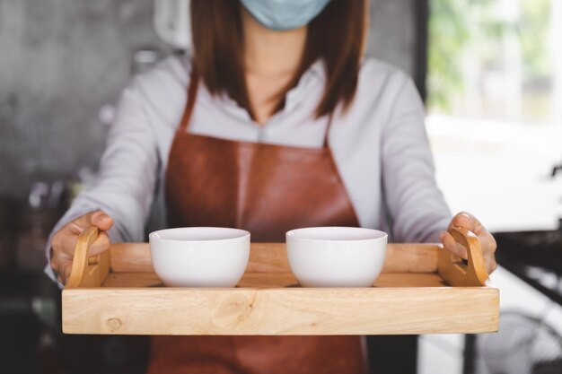 Midsection of woman holding food in tray