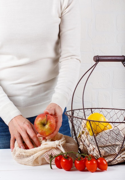 Midsection of woman holding fruits in basket