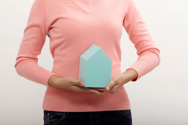 Midsection of woman holding hands against white background