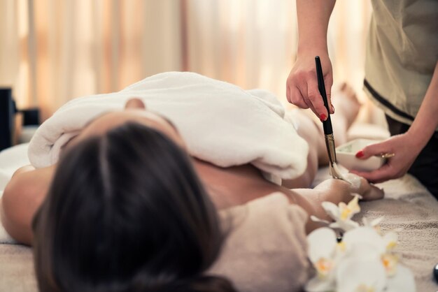 Photo midsection of woman holding hands lying on floor