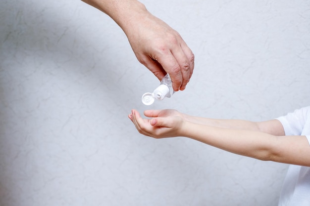 midsection of woman holding hands over white background