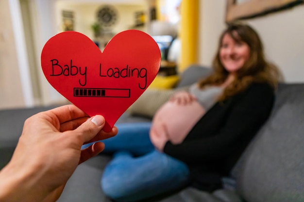 Photo midsection of woman holding heart shape with text