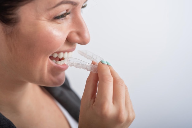 midsection of woman holding ice cream against white background