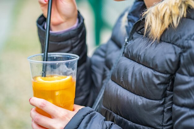 Midsection of woman holding juice in glass