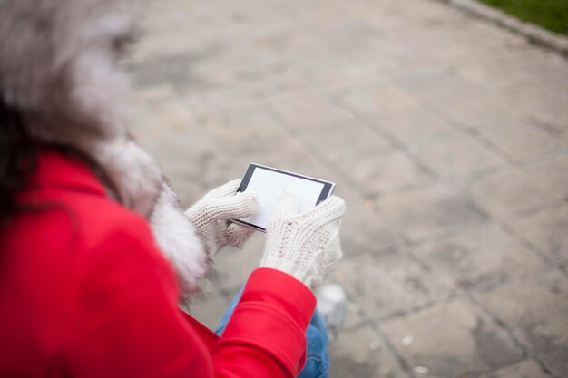 Midsection of woman holding mobile phone