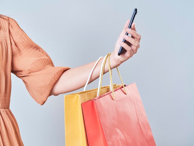 Midsection of woman holding mobile phone