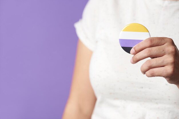 Midsection of woman holding pills against blue background